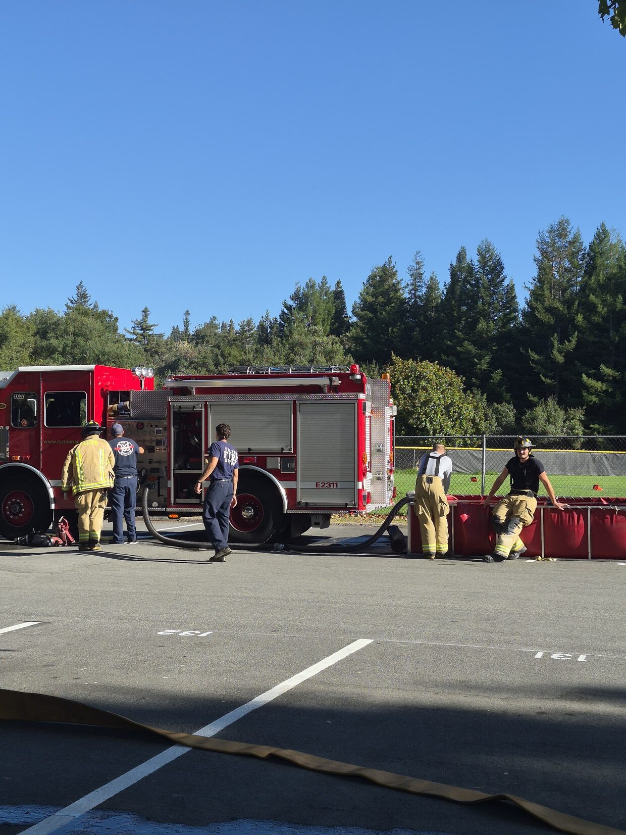 Engine 2311 drafting water from a portable tank