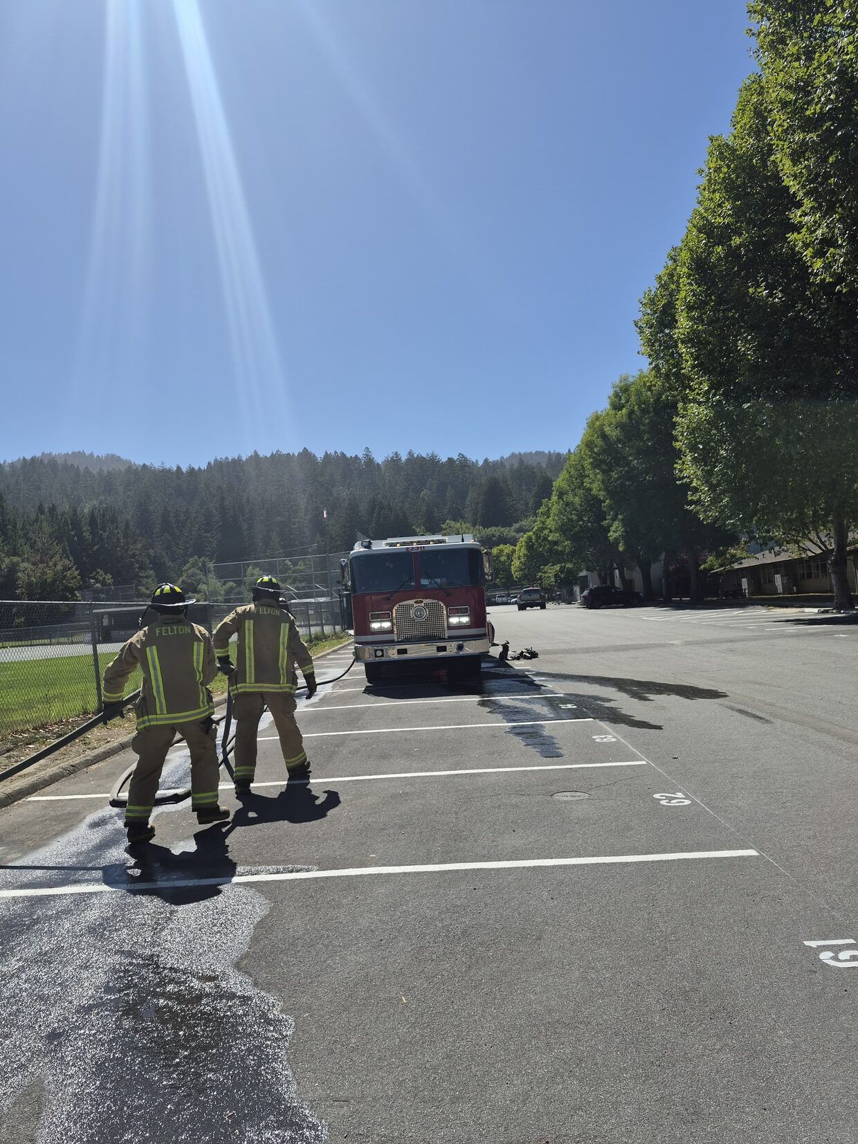 Two Felton firefighters advancing a charged hose line