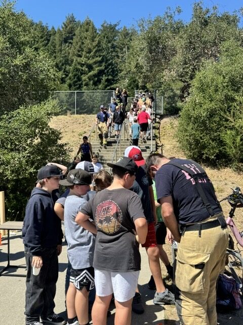 Felton firefighters in full turnouts and air packs at the base of a long outdoor stairway