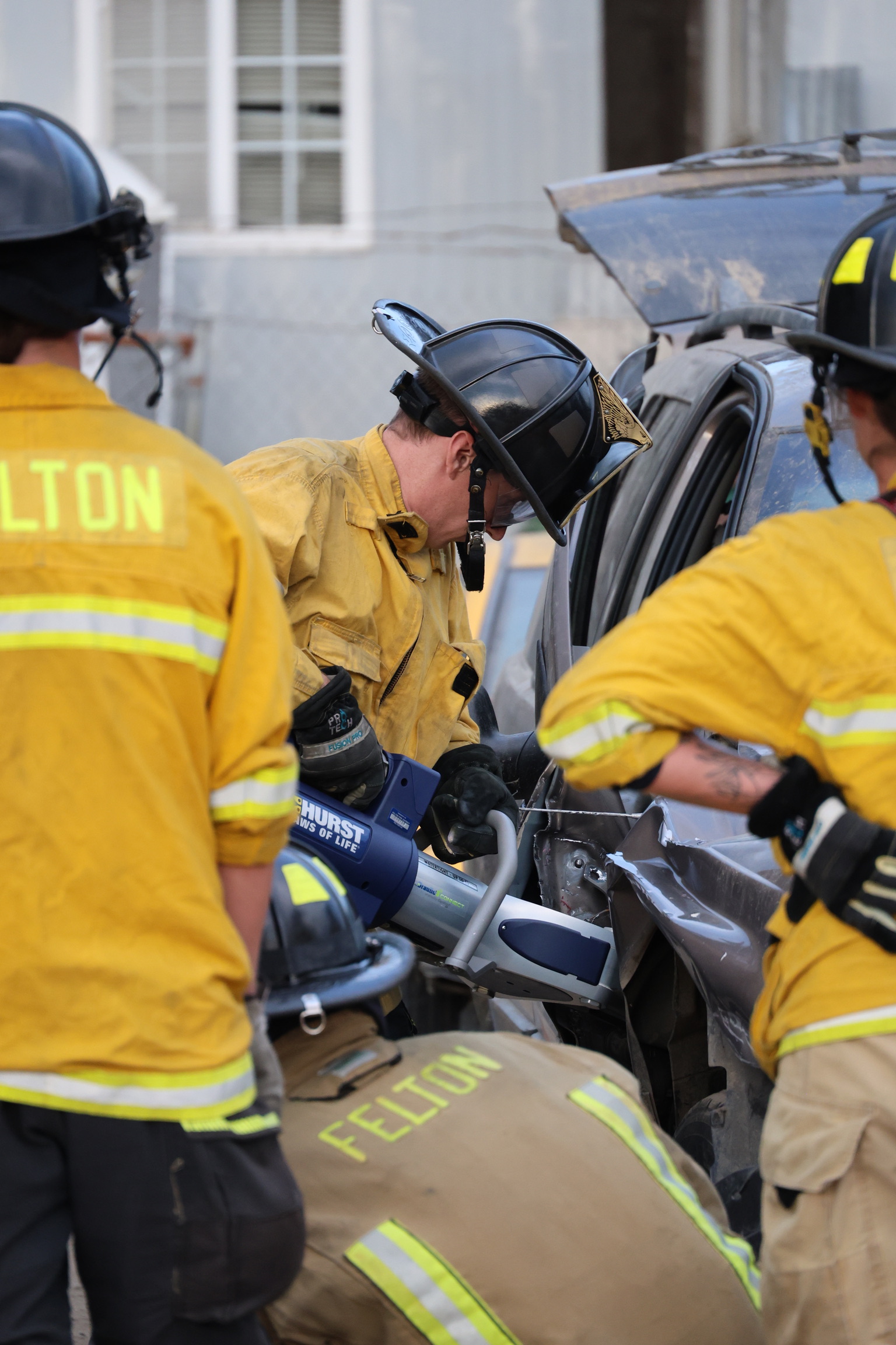 Felton firefighter using a Hurst hydraulic spreader on a vehicle